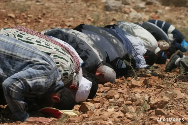 Palestinians pray during a demonstration against the construction of Israel's disputed barrier in the West Bank village of Nilleen near Ramallah.