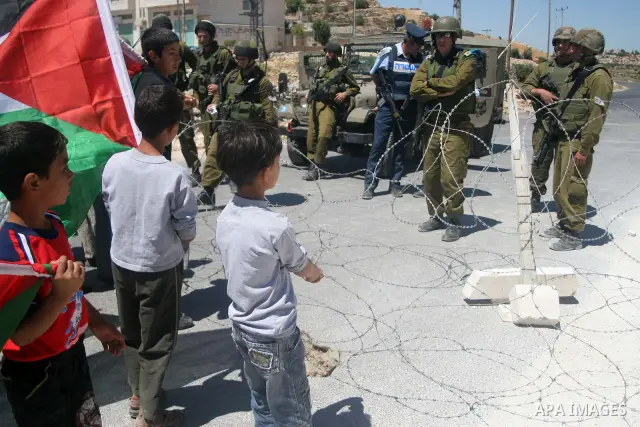 Israeli soldiers detain a foreign activists during a demonstration against the construction of the controversial Israeli separation barrier in the village of Maasarah near the West Bank town of Bethlehem. Israel says the...