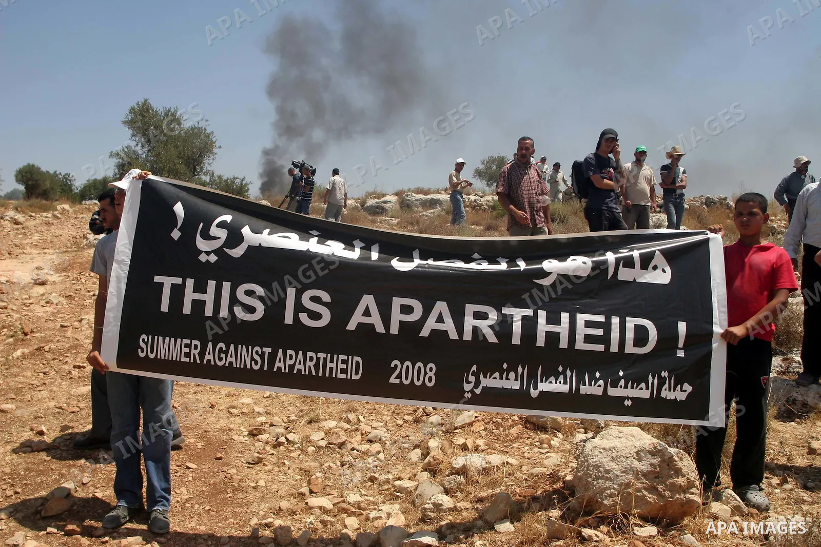 Palestinians hold placard during a demonstration against the construction of Israel's disputed barrier in the West Bank village of Nilleen near Ramallah.