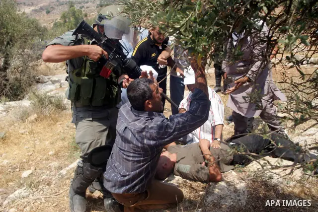 Israeli soldiers scuffle with Palestinian and international protestors during a demonstration against the construction of the controversial Israeli cement barrier in the West Bank village of Nilin near Ramallah. Sixteen...