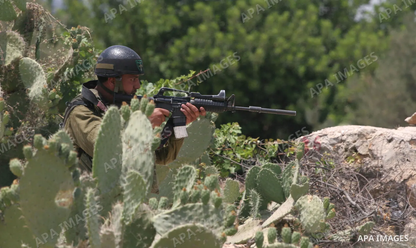Israeli soldiers fire teargas and rubber bullets at Palestinian and foreign protestors during a demonstration against the construction of the controversial Israeli cement barrier in the West Bank village of Nilin near Ra...