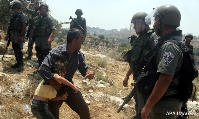 Israeli soldiers scuffle with Palestinian and international protestors during a demonstration against the construction of the controversial Israeli cement barrier in the West Bank village of Nilin near Ramallah. Sixteen...