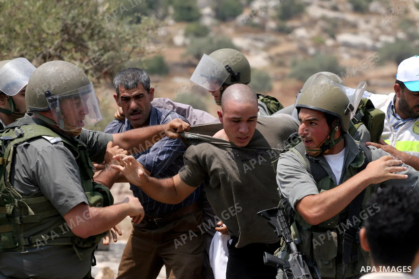 Israeli soldiers scuffle with Palestinian and international protestors during a demonstration against the construction of the controversial Israeli cement barrier in the West Bank village of Nilin near Ramallah. Sixteen...