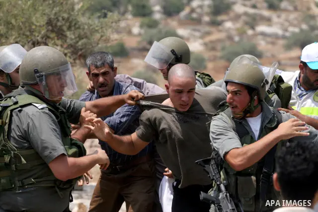 Israeli soldiers scuffle with Palestinian and international protestors during a demonstration against the construction of the controversial Israeli cement barrier in the West Bank village of Nilin near Ramallah. Sixteen...