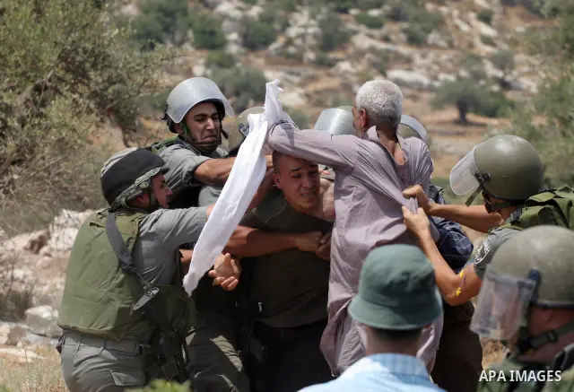 Israeli soldiers scuffle with Palestinian and international protestors during a demonstration against the construction of the controversial Israeli cement barrier in the West Bank village of Nilin near Ramallah. Sixteen...
