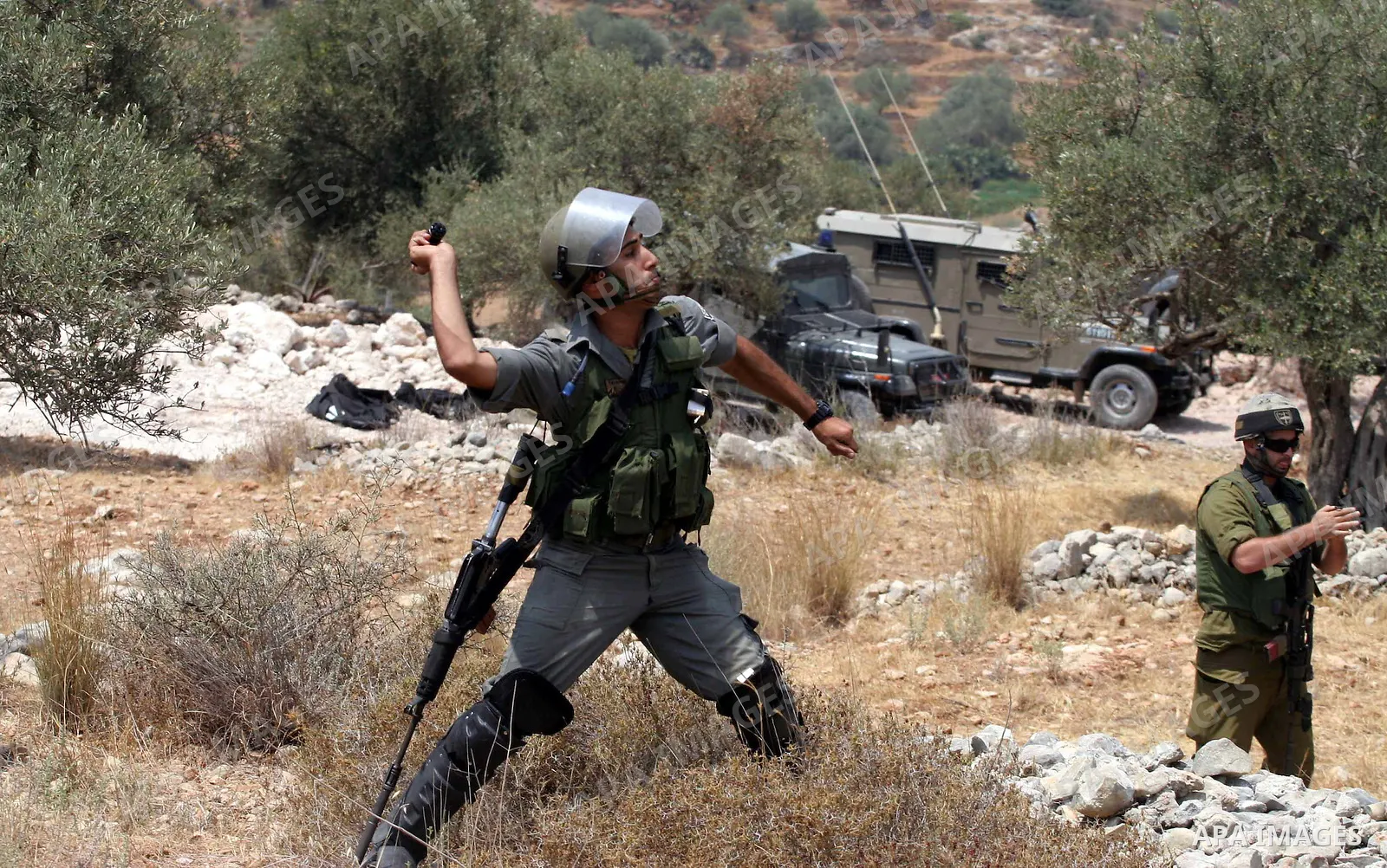 Israeli soldiers fire teargas and rubber bullets at Palestinian and foreign protestors during a demonstration against the construction of the controversial Israeli cement barrier in the West Bank village of Nilin near Ra...