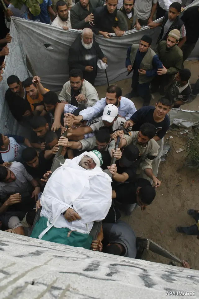 Palestinians carry the body of Hamas militant Ahmed Suleiman during his funeral in Rafah town in the southern Gaza Strip. Suleiman was one of four Hamas fighters who detonated two booby-trapped vehicles disguised as Isra...
