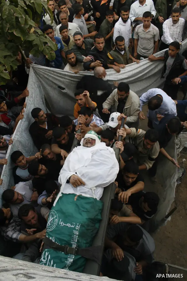 Palestinians carry the body of Hamas militant Ahmed Suleiman during his funeral in Rafah town in the southern Gaza Strip. Suleiman was one of four Hamas fighters who detonated two booby-trapped vehicles disguised as Isra...