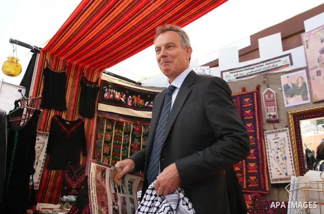 Former British Prime Minister and Middle East peace envoy Tony Blair visits an exhibition, at the Convention Palace, during the Palestine Investment Conference in Al-Khader village near the West Bank city of Bethlehem. B...