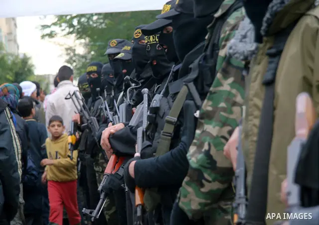 Masked Palestinian militants hold their weapons during an Islamic Jihad rally in Bureij, central Gaza Strip, Friday, Dec. 26, 2008. Israeli defense officials say politicians have approved a large-scale incursion into the...