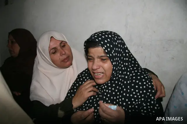 A relatives of Ali Hijazi, a Palestinian member of al-Aqsa Martyrs Brigades, mourn during his funeral in the town of Beit Lahiya in the northern Gaza Strip. An Israeli air strike killed Hijazi in the Gaza Strip on Saturd...