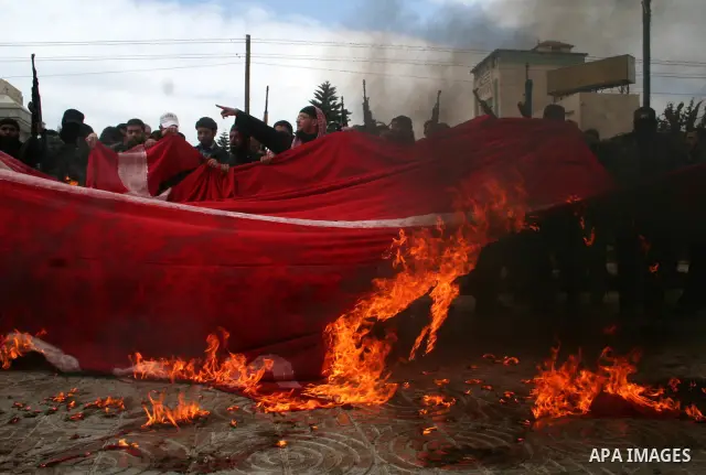 Palestinians burn a flag of Denmark during a protest in Gaza. The rally, organised by popular resistant committees, was a protest against a cartoon of Prophet Mohammad that was republished by Danish newspapers on Februar...