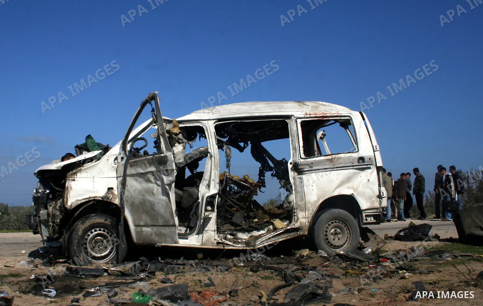 Palestinians inspect a destroyed vehicle belonging to Hamas Police after it was targeted by an Israeli air strike in the southern Gaza Strip February 27, 2008. Israeli air strikes killed at least six Palestinians in the...