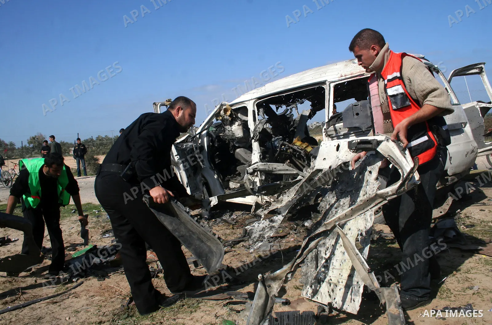 Palestinians inspect a destroyed vehicle belonging to Hamas Police after it was targeted by an Israeli air strike in the southern Gaza Strip February 27, 2008. Israeli air strikes killed at least six Palestinians in the...