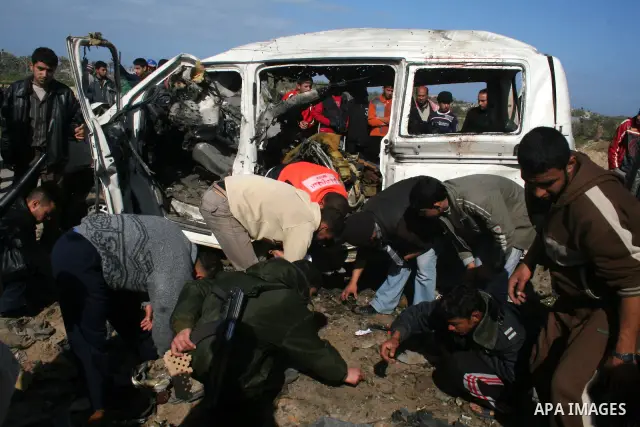 Palestinians inspect a destroyed vehicle belonging to Hamas Police after it was targeted by an Israeli air strike in the southern Gaza Strip February 27, 2008. Israeli air strikes killed at least six Palestinians in the...