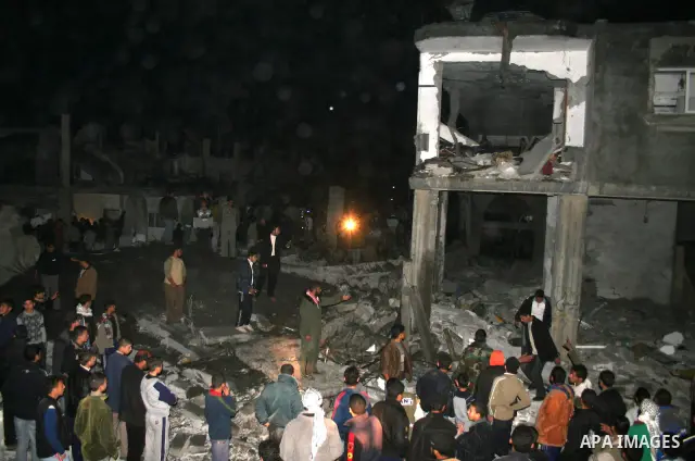 Palestinians inspect the site of an Israeli raid in the Bureij refugee camp, central Gaza Strip. At least nine people were killed , more than 40 wounded today when an Israeli aircraft targeted the home of an Islamic Jiha...