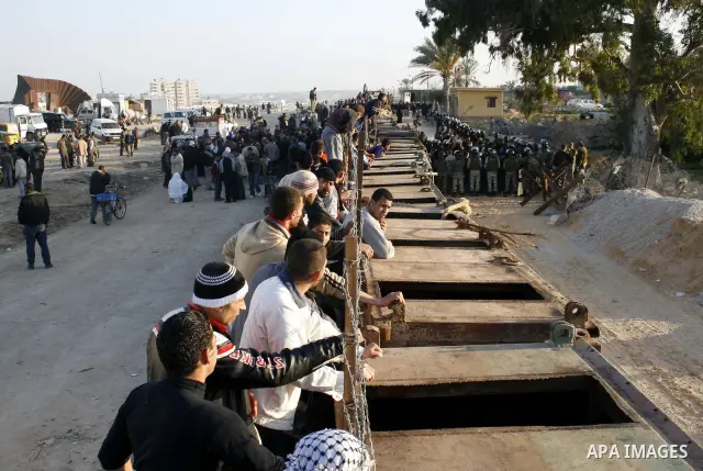 Palestinians who was stuck at Egypt as they wait to cross into Gaza at Rafah's border crossing, southern Gaza Strip. Egypt has warned Palestinians against trying to break through its resealed Gaza border about two weeks...