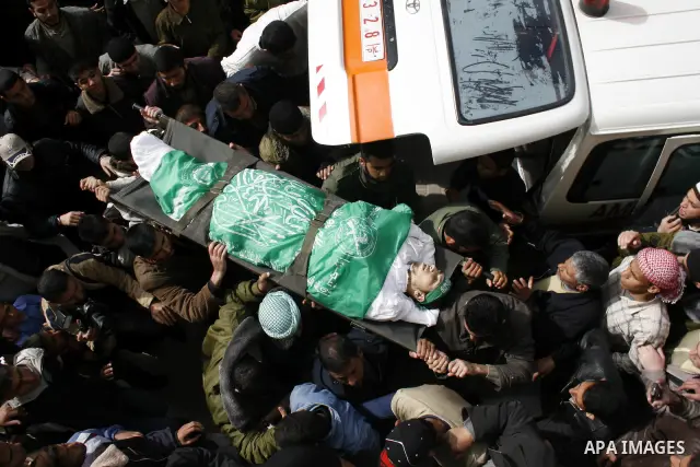 Palestinian mourners carry the body of Hamas militant Mohammed Meteir during his funeral in Rafah refugee camp, southern Gaza Strip. Meteir was killed by an Israeli air strike late Saturday, hours after two Israeli broth...