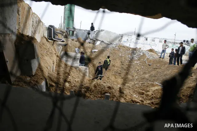 Palestinian children play at Hamas training camp after it was destroyed by Israeli air strike in Rafah, southern Gaza Strip. two Israeli brothers, ages 8 and 19, were seriously wounded when a rocket from Gaza slammed int...