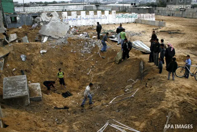 Palestinian children play at Hamas training camp after it was destroyed by Israeli air strike in Rafah, southern Gaza Strip. two Israeli brothers, ages 8 and 19, were seriously wounded when a rocket from Gaza slammed int...