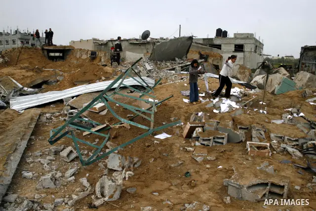 Palestinian children play at Hamas training camp after it was destroyed by Israeli air strike in Rafah, southern Gaza Strip. two Israeli brothers, ages 8 and 19, were seriously wounded when a rocket from Gaza slammed int...