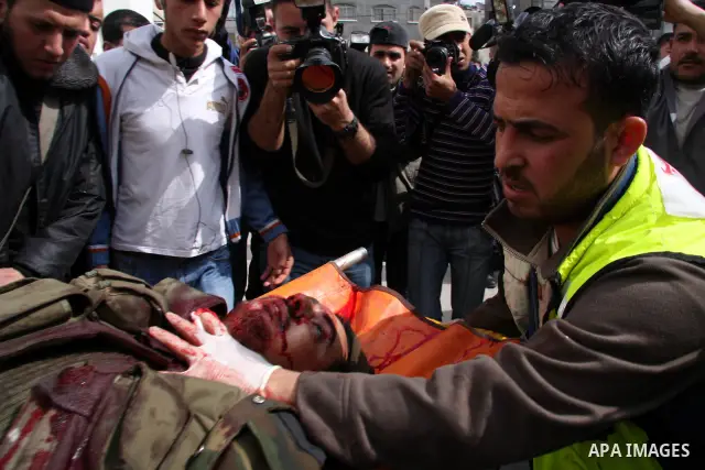 Palestinian medical workers carry a wounded into a hospital at Beit Lahia in the northern Gaza Strip. Israel pressed its assault against the Hamas-ruled Gaza Strip with a surge of strikes today, killing at least 32 Pales...