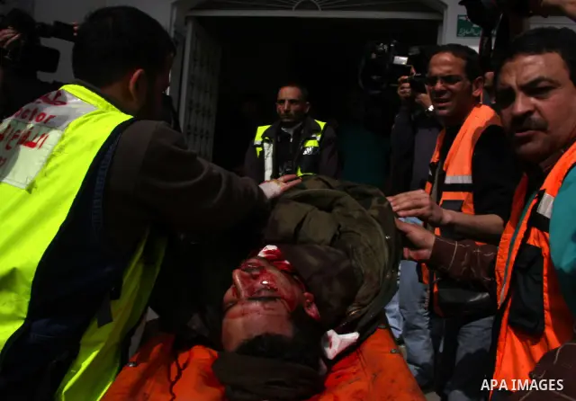 Palestinian medical workers carry a wounded into a hospital at Beit Lahia in the northern Gaza Strip. Israel pressed its assault against the Hamas-ruled Gaza Strip with a surge of strikes today, killing at least 32 Pales...