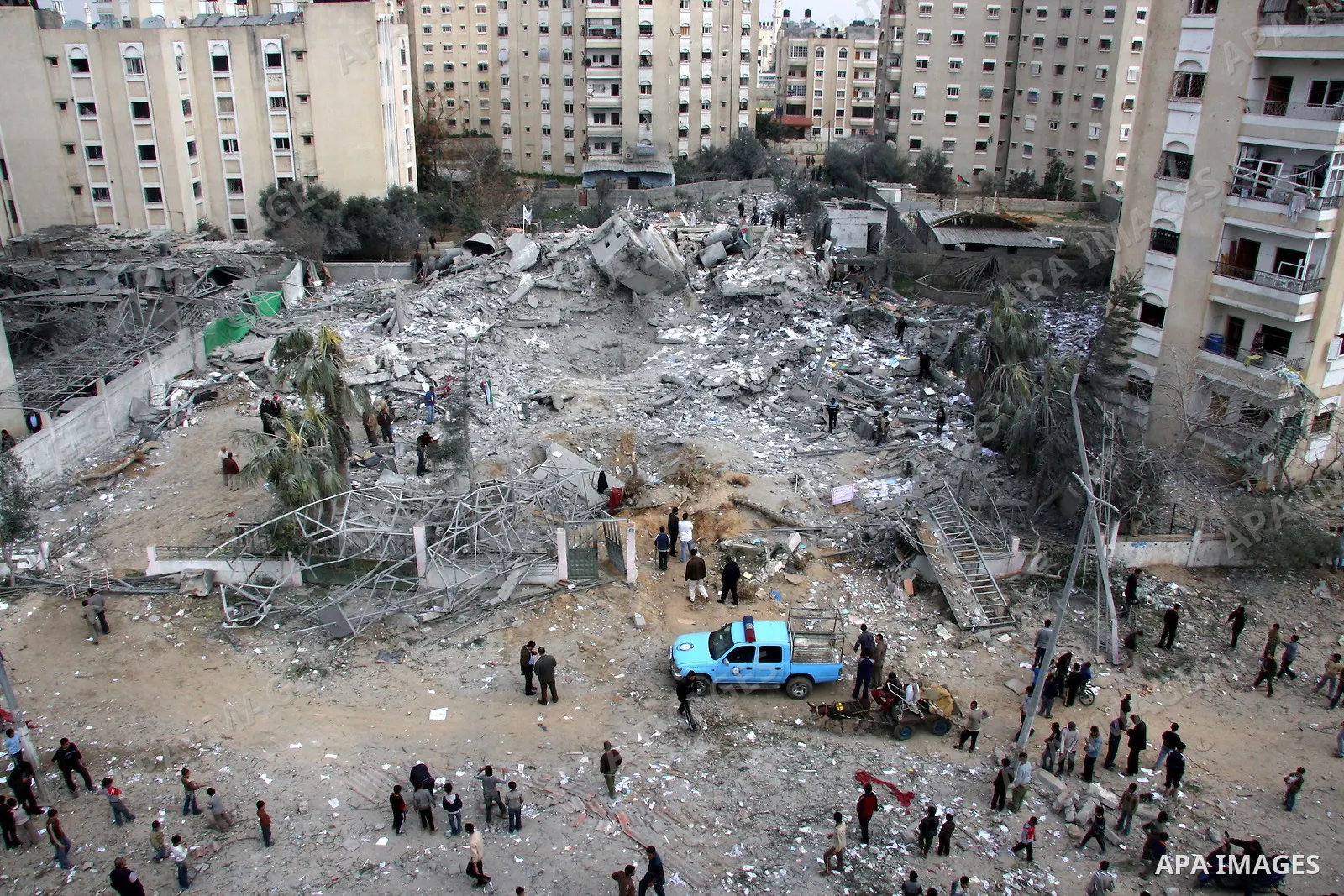 Palestinians inspect the destroyed labour syndicate headquarters after it was targeted by Israeli airstrike, in Gaza City. Israeli Deputy Defence Minister Matan Vilnai warned today that Israel would keep up its deadly ra...