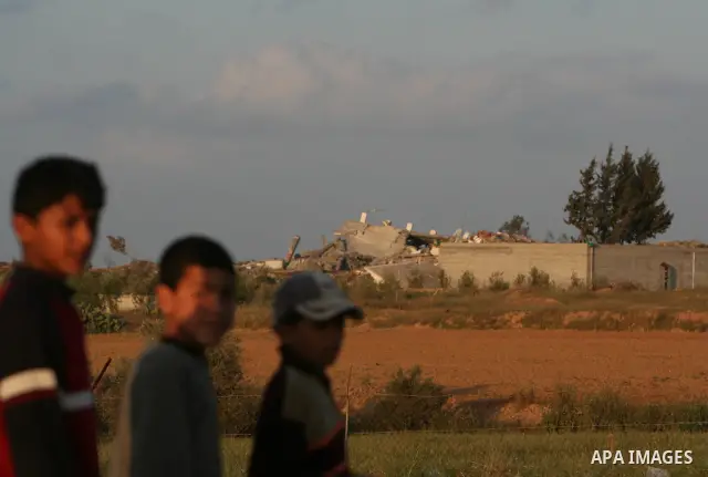 A Palestinian boy looks at a destroyed house following an Israeli air strike in Deir al-Balah in the central Gaza Strip on April 16, 2009. Israeli aircraft bombed the house in the Gaza Strip in the first strike on the Ha...