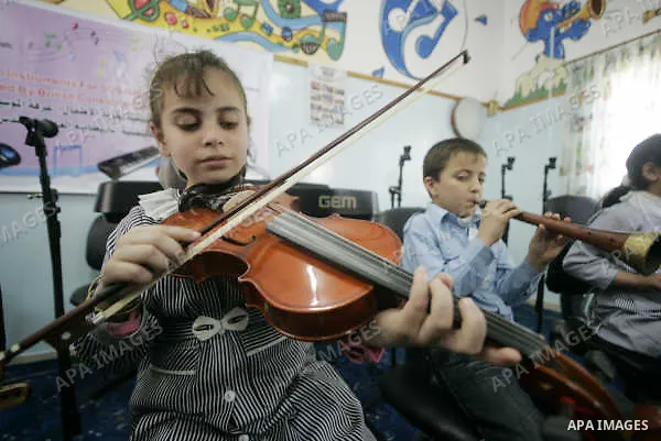 A Palestinian orphans play music in the SOS Children's Village in Rafah the southern Gaza Strip on June 30, 2009. The school for orphans that was established in 2000 with the sponsorship of the Austrian SOS international...