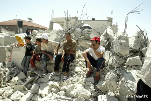 A Palestinians inspect the rubble of their house which demolished by Israeli bulldozer in East Jerusalem on June 30, 2009. photo by Mahfuz Abu Turk