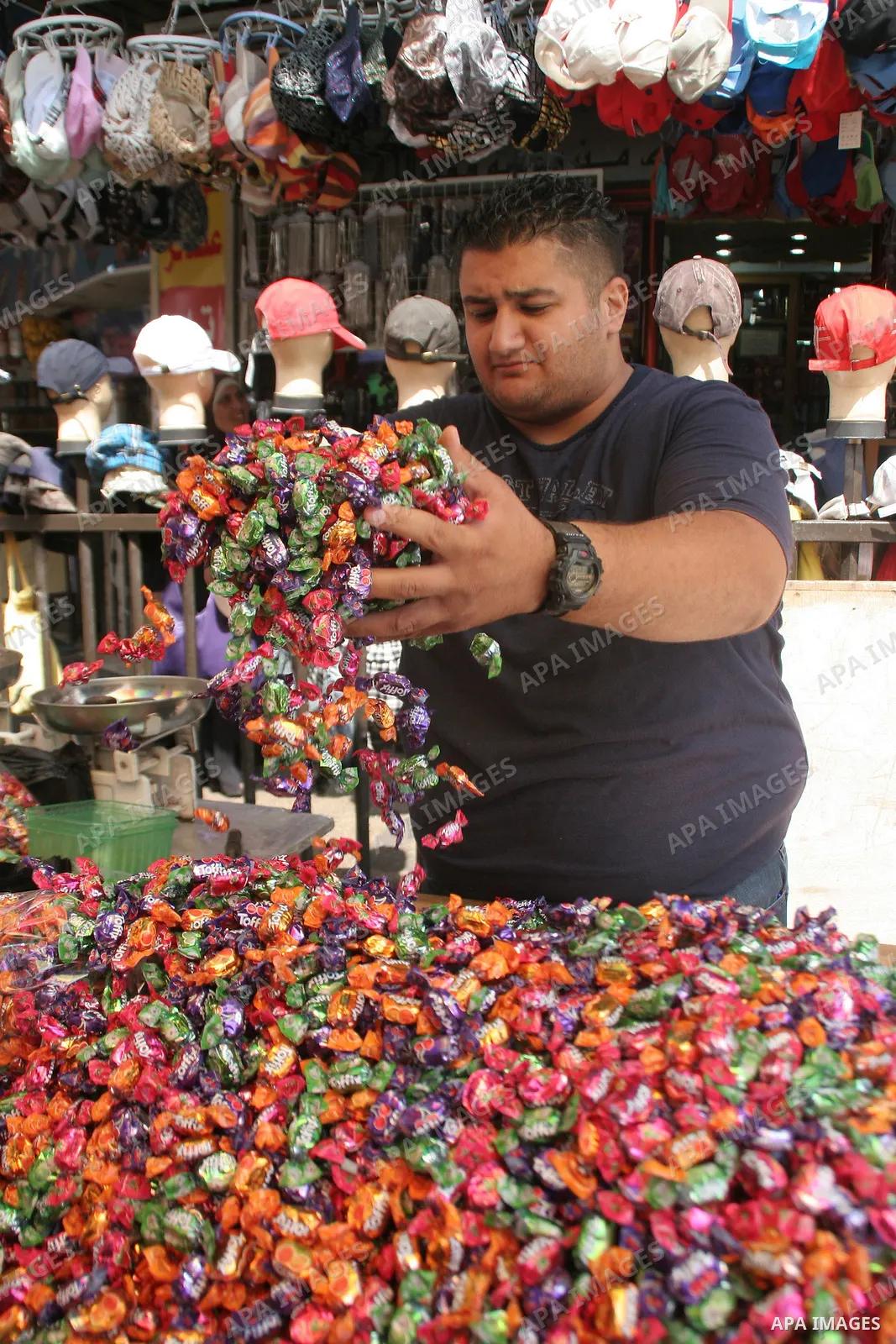 A Palestinian vendor displays sweets in the middle of the market in the West Bank city of Nablus on Sep 19, 2009. Photo Nedal Shtieh .