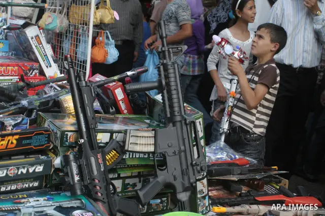 A Palestinian vendor displays kids toys in the middle of the market in the West Bank city of Nablus on Sept 19, 2009. Photo Nedal Shtieh.