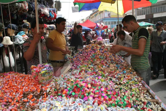 A Palestinian vendor displays sweets in the middle of the market in the West Bank city of Nablus on Sep 19, 2009. Photo Nedal Shtieh .
