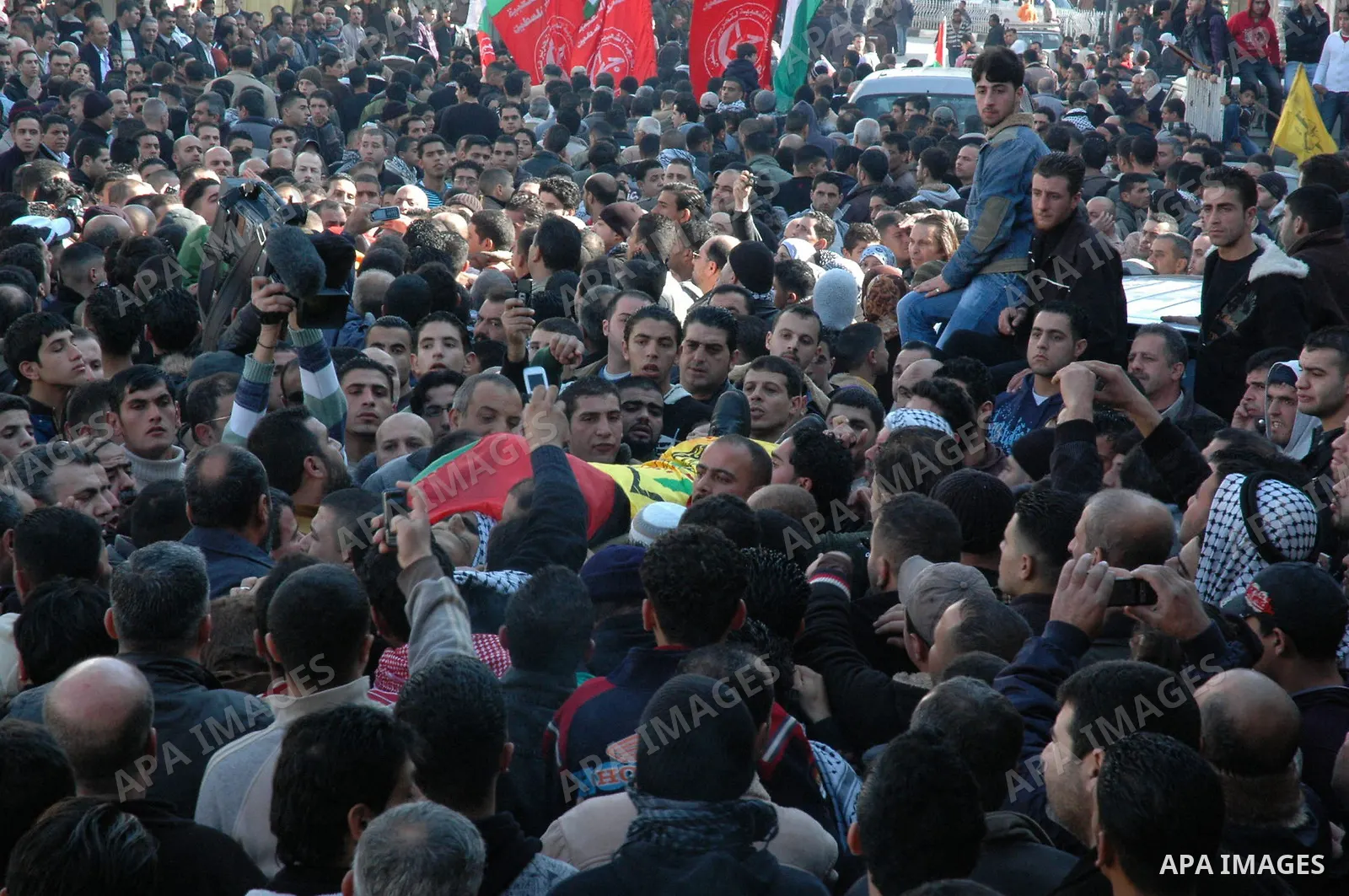 Palestinian mourners carry the bodies of Palestinians killed by Israeli soldiers earlier in the day during a military operation in the West Bank city of Nablus on December 26, 2009. Israeli forces stormed into the old ci...