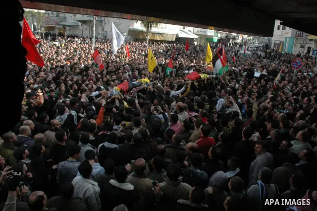Palestinian mourners carry the bodies of Palestinians killed by Israeli soldiers earlier in the day during a military operation in the West Bank city of Nablus on December 26, 2009. Israeli forces stormed into the old ci...