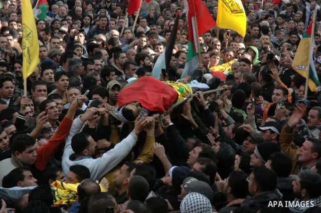Palestinian mourners carry the bodies of Palestinians killed by Israeli soldiers earlier in the day during a military operation in the West Bank city of Nablus on December 26, 2009. Israeli forces stormed into the old ci...