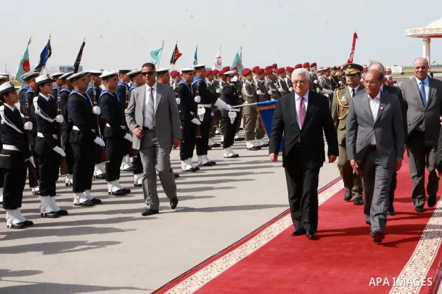 Tunisian President Moncef Marzouki (R) reviews the honour guard with Palestinian President Mahmoud Abbas upon his arrival on April 28, 2012 in Tunis. Abbas is on three-day official visit to Tunisia. Photo by Thaer Ganaim
