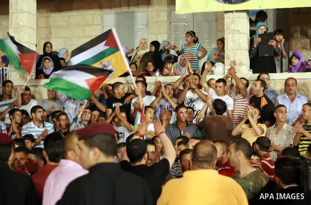 Palestinians celebrate during a mass wedding for 19 Groom, participation of Palestinian President Mahmoud Abbas (not seen) in the village of Silwad in the West Bank city of Ramallah, June 28, 2012. Photo by Thaer Ganaim