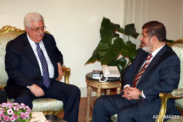 Palestinian President Mahmoud Abbas (Abu Mazen) (L) meets with Egypt's President Mohamed Morsi at the presidential palace in Cairo July 18, 2012 . Photo by Thaer Ganaim