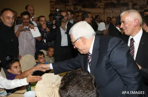 Palestinian President, Mahmoud Abbas (Abu Mazen), participates in breakfast with the group of Palestinian orphans in the West Bank city of Hebron on, Aug. 01, 2012. Photo by Thaer Ganaim