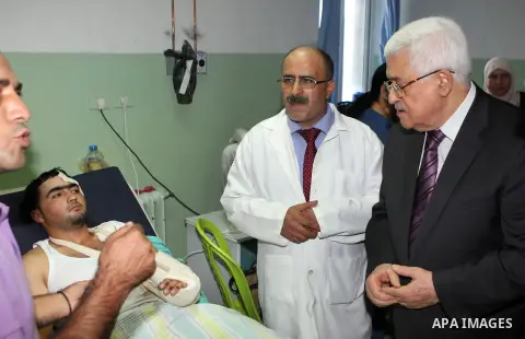 Palestinian President Mahmoud Abbas ( Abu Mazen ) visits patients in Ramallah governmental hospital in the West Bank city of Ramallah, on Aug 23, 2012. Photo by Thaer Ganaim