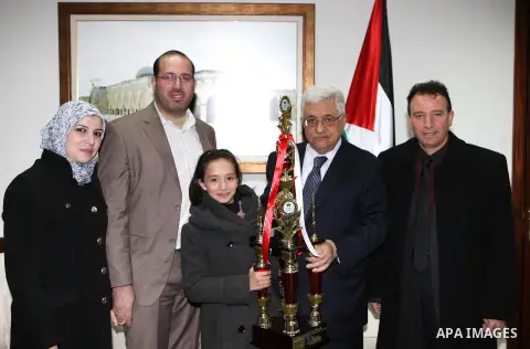 Palestinian President Mahmoud Abbas (Abu Mazen) meets with Dania Jabari the second place winner of the Intelligence competition, in the West Bank city of Ramallah, on Jan. 08, 2013. Photo by Thaer Ganaim