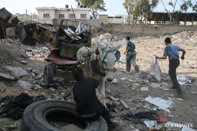 Palestinians collect rubbish for re-sale at a dump site in Gaza City in the impoverished Gaza Strip. Some Palestinians, driven by poverty exacerbated by the Israeli blockade and lack of employment opportunities, have res...