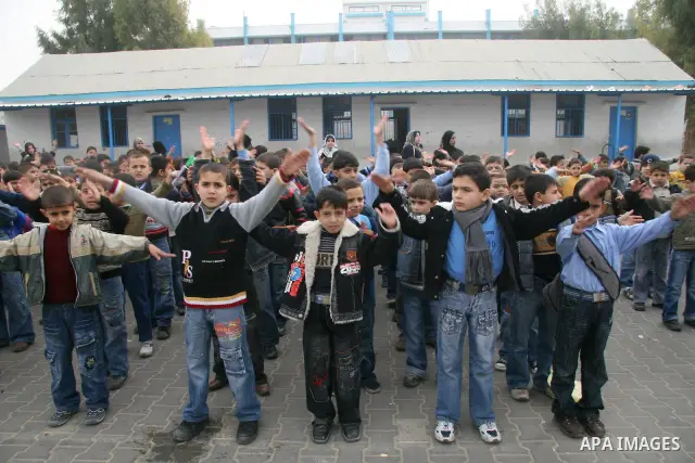 Palestinian school boys participate in morning exercises at Beach Elementary School for Boys at Shati refugee camp in Gaza City, Saturday, Jan. 24, 2009. Tens of thousands of children wearing uniforms and carrying satche...