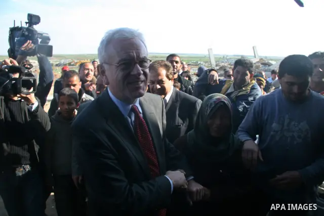 European Union (EU) Parliament President Hans-Gert Poettering (R) hold hands with a Palestinian man during a visit to a Jabalia district that was bombed during Israel's 22-day offensive on the Gaza Strip, on February 23,...