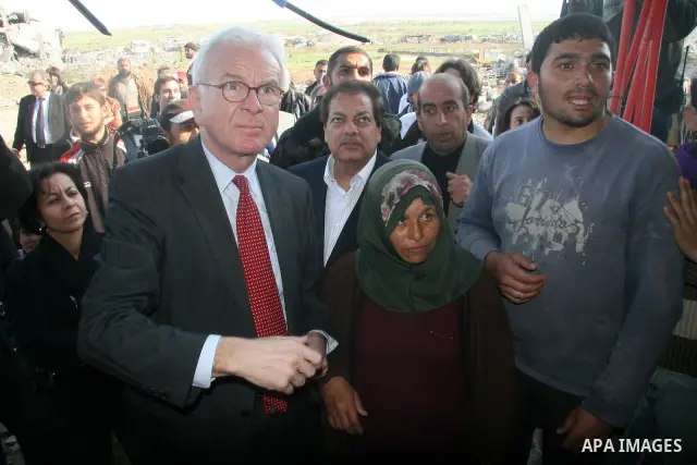 European Union (EU) Parliament President Hans-Gert Poettering (R) hold hands with a Palestinian man during a visit to a Jabalia district that was bombed during Israel's 22-day offensive on the Gaza Strip, on February 23,...