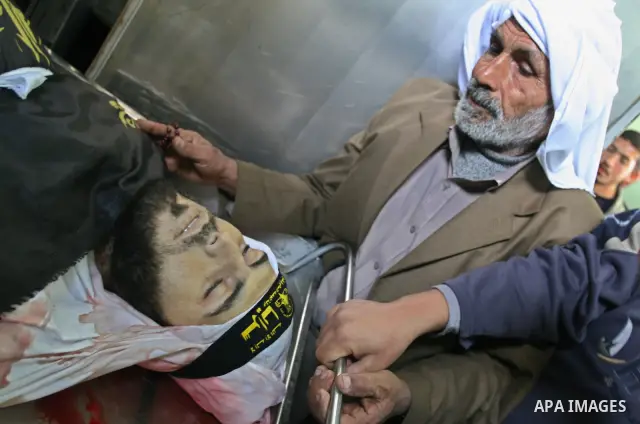 Relatives gather next to the body of Islamic Jihad militant Khaled Shalan at the morgue of Kamal Edwan hospital in Beit Lahiya, northern Gaza Strip, Thursday, March 5, 2009. An Israeli air strike in the Gaza Strip Thursd...