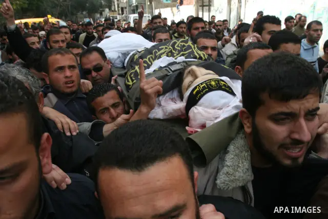 Palestinian mourners carry the body of Islamic Jihad commander Khaled Shalan, killed in an Israeli strike, during his funeral in Beit Lahia, northern Gaza Strip, on March 5, 2009. Israel killed four militants in separate...