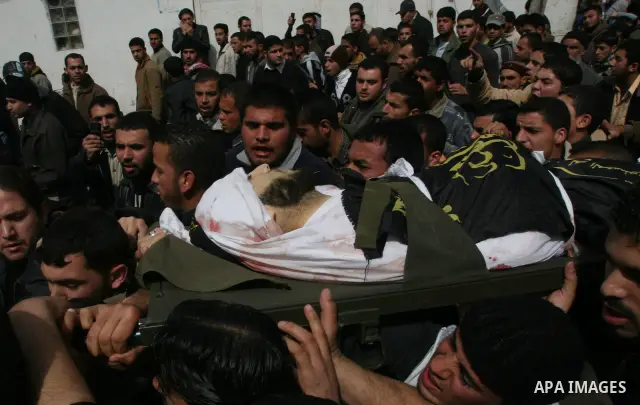 Palestinian mourners carry the body of Islamic Jihad commander Khaled Shalan, killed in an Israeli strike, during his funeral in Beit Lahia, northern Gaza Strip, on March 5, 2009. Israel killed four militants in separate...